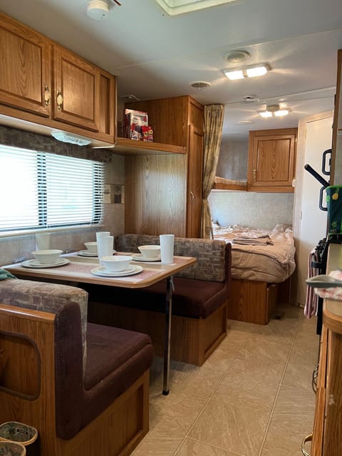 Ample storage above and below, the dining table is ready for your next meal, or a good night’s sleep for two!