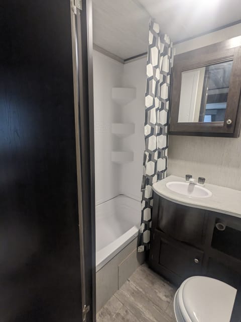 Bathroom with shower and tub. More head room than typical travel trailers in shower area