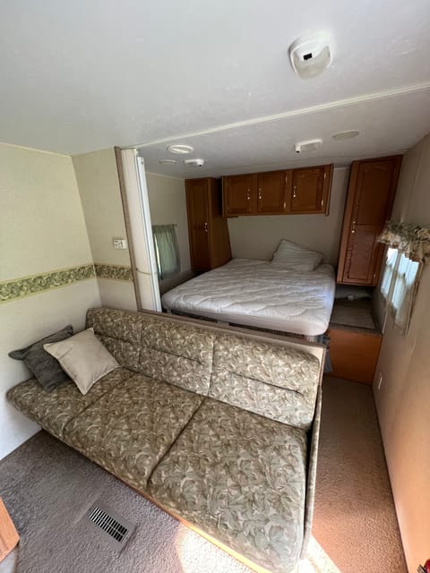 Bedroom in front of camper and fold down couch