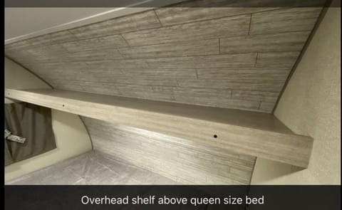 Overhead, open storage shelf
Window at the head of the bed opens!