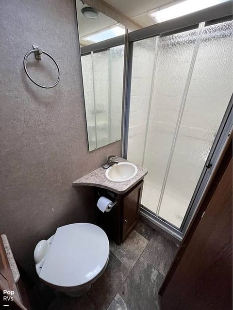 Bath with walk in shower. There is a countertop extender, and a cabinet to store your personal bath items. Linens included.