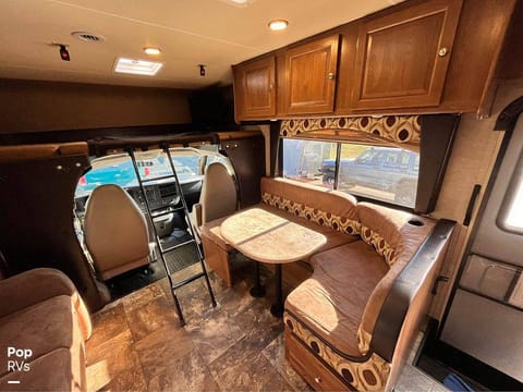 Spacious dining and living area, even when on the road! Table and sofa each fold into a twin bed.