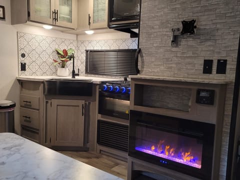 Farm house style kitchen. This also showcases our electric fireplace.
