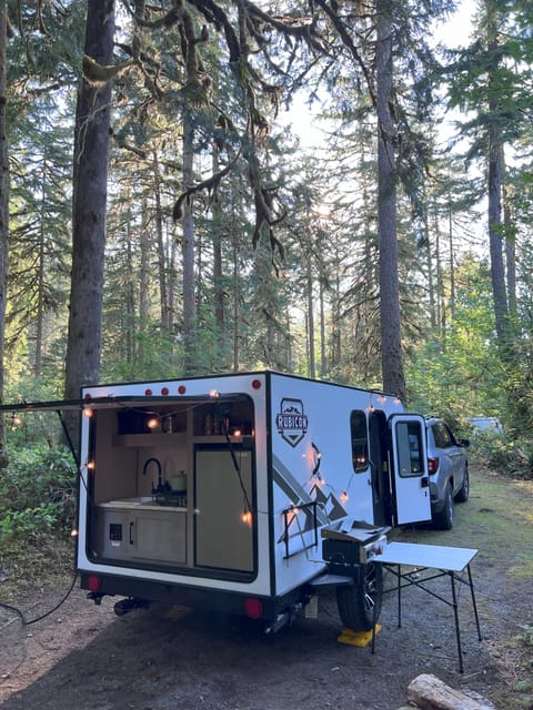 The outdoor kitchen is accessed from the back of the unit. The griddle mounts on the installed bracket on the left side of the trailer.