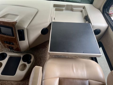 Lap desk for up front passenger with outlet for working on the go.