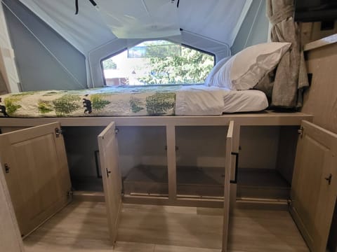 This trailer surprisingly has a lot of storage: cabinets under the beds, above the beds, under the TV, in the bathroom.