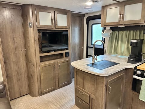 The front of the trailer -- TV and storage area. The master bedroom is behind the sliding doors on either side of the entertainment center.