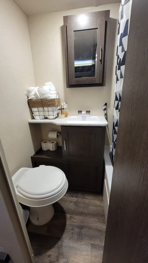 Full bath including flushable toilet, sink, shower with tub. 