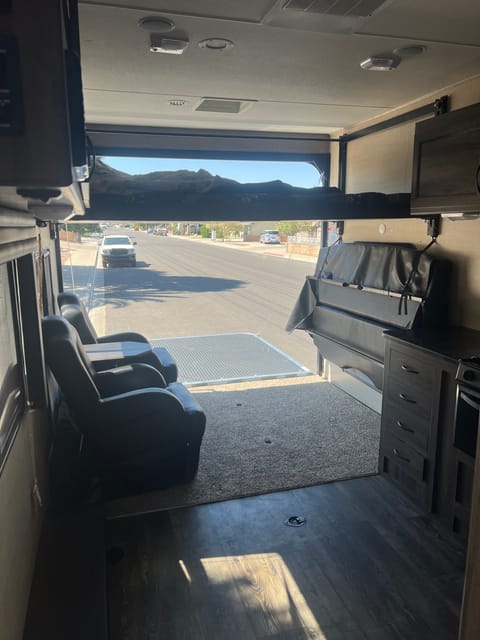 This extra bed can be brought down and brought up to store more equipment. The couch on right can be used as a bed as well.