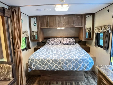 Brand new queen-size bed. Each side of the bed has a wardrobe, two windows, and a skylight. A privacy curtain can slide over for extra privacy
