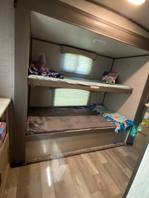 The kids bunkroom. Under the bottom bunk is storage to hold everything for a cleaner room during the trip. Games, books and coloring included as well.