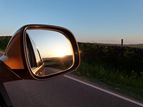 An arty shot of a sunset viewed in the wing mirror of Bea