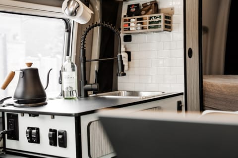 The interior kitchen has been upgraded thoughtfully. A portable cook top can be used inside or out. A kettle, hand-grinder, and pour over setup are included. 