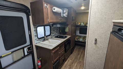 Fully-equipped kitchen includes everything needed to cook up a fun-filled trip! Plus plenty of storage and a HUGE easy-access cabinet next to bunks!