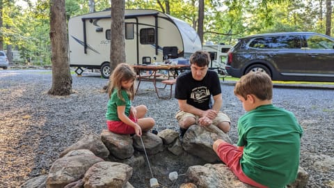 Our family using our beloved camper (we tow with a 2021 Kia Telluride 4WD) <3