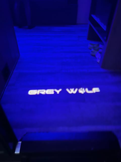 Grey wolf logo light on entrance of trailer living room 