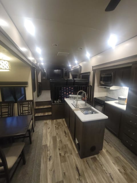 Kitchen, dining table, and kitchen island.