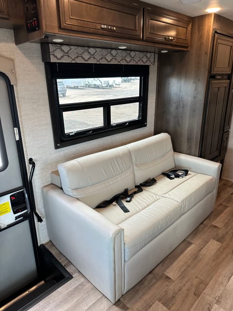 Couch is a fold out (like a futon). Two seatbelts mean this is a comfortable place to sit while the RV is in motion.