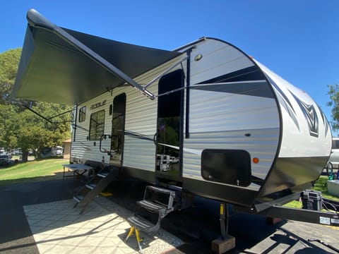 The unit has two exterior doors leading to the living area and the bedroom, as well as a full awning to keep you cool!