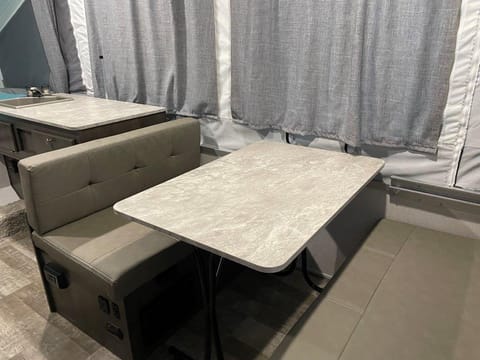 Dining room table with sink behind it