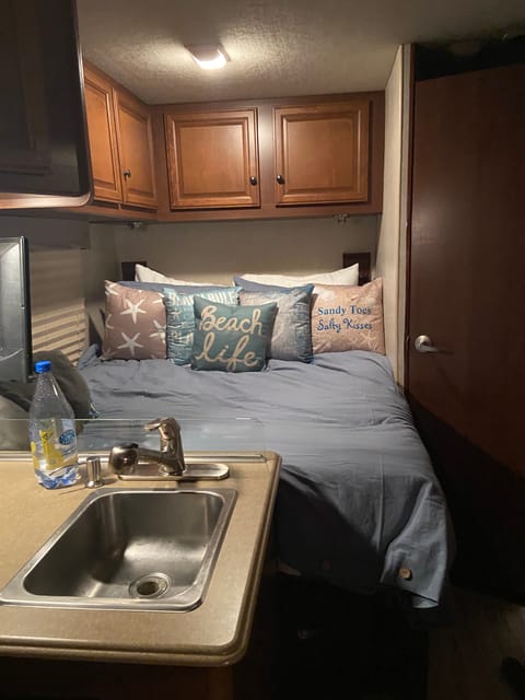 Close up of main bed in the rear of the RV.
