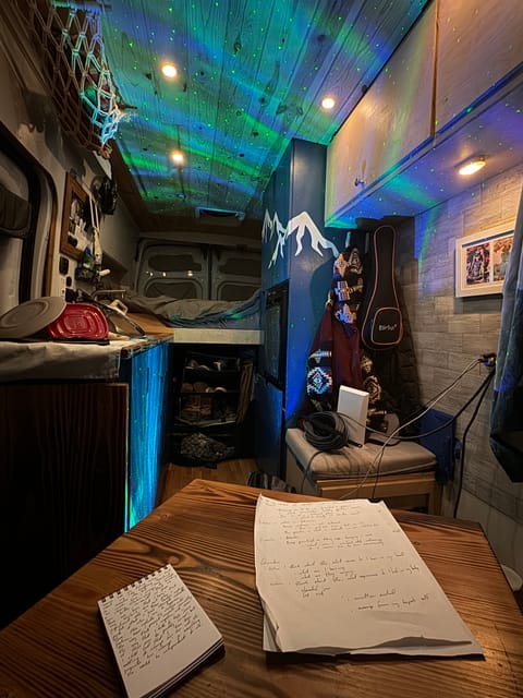 Interior of the van, sitting in the reversible passenger seat looking towards the back of the van