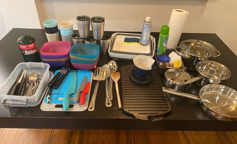 Silverware, griddle,cups, knifes, pans cutting boards, coffee cups, wash basin, coffee drip filter, paper towels, garbage bags, pan spray,..etc,