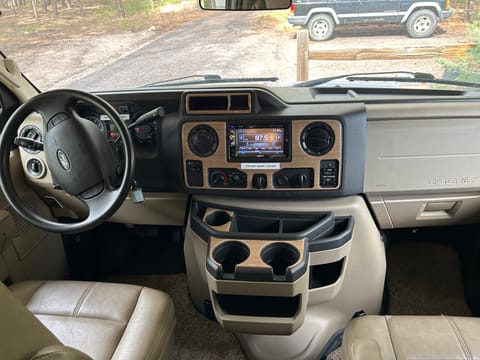 Cab includes captains chairs, Bluetooth, side and rear view cameras, HDMI connections, emergency starting switch, audio system includes speaker control with speakers in front and rear of RV. There are also speakers on the exterior of the RV.