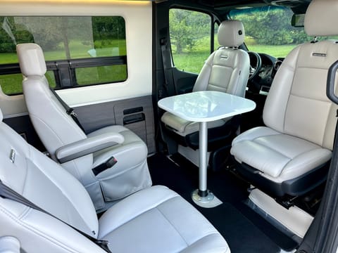 The two front seats flip around to provide a four seat dining area with table.