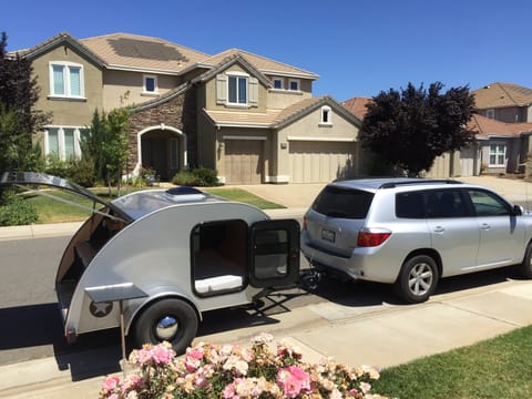 Teardrop trailer in front of my house hitched to my Highlander to show size.