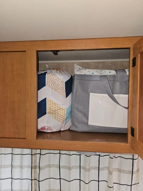 Cabinet containing the (optional) bedding for the sofa bed and dinette bed. 