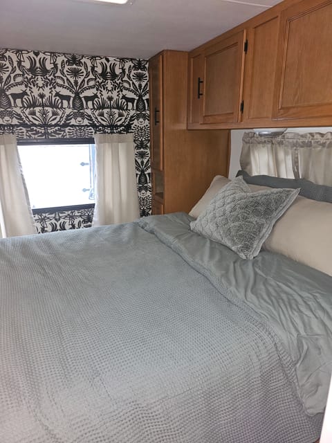 The main bedroom has a queen size bed with an upgraded mattress, a sliding door for privacy and plenty of cabinets for storage. 