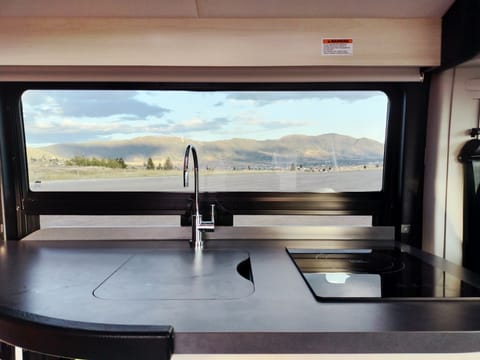 Sink and induction stove top and counter space with a great view!