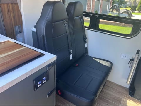 Extra two seats - with custom table, plug ins for charging and car seat anchors for kiddo safety!