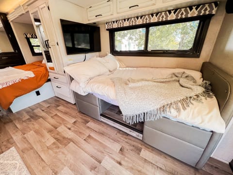 Dinette converts into twin size bed with a queen that fits 2 adults in the back. 