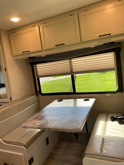 Kitsches table has hands free cell phone charger. The table moves to chair level and turns into a bed sleeps two people