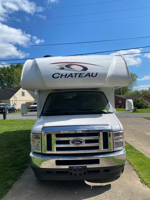 Side view of RV has a regular door and screen door