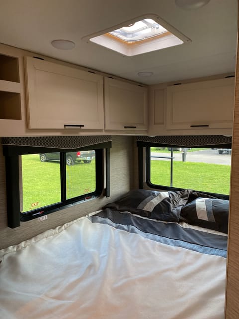 Bedroom sleeps two has plenty of storage space and two cell phone chargers, screen windows and central air conditioner control located on bedroom wall