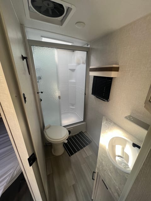 Spacious bathroom with hot water. Trailer is equipped with 6-gallon water heater.  