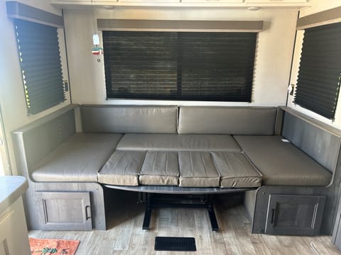 Dinette as a bed.  Can easily fit someone over 6ft