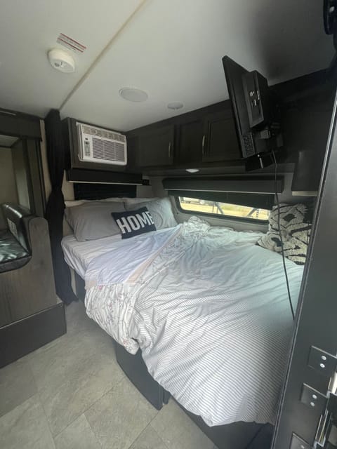 Main queen bed with tv/ac unit