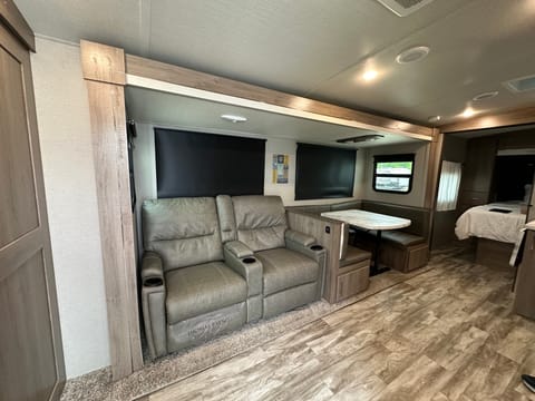 Two reclining theatre seats for unwinding after a long day on the trails! And a U-shaped dinette for enjoying a meal or working remotely! 