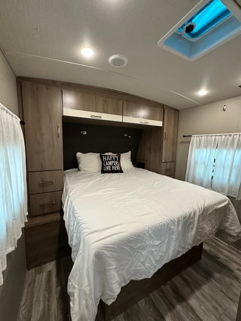 Private bedroom. Residential queen mattress with a plush mattress topper for extra comfort. 