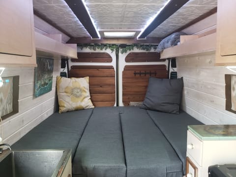 The bed area is nearly queen sized, easily fitting 2 large adults. It can be easily converted into a table with the center cushions being used for bac