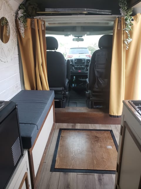 Looking from the bed towards the front of the van, you have the bench seat on the left, and the shower pan on the floor.