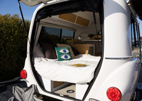 Imagine enjoying the view here in the comfort of bed. The rear door includes a roll down privacy screen so you can continue to get airflow while keeping any critters out. 
