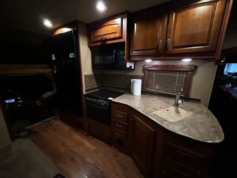 Kitchen with full residential fridge. 