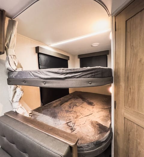 Relax in comfort with these cozy bunk beds, all while taking in the stunning views from the large windows. Each bunk has its own individual controlled