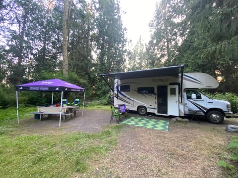 Campsite set up. The awning is power extendable and the rental comes with outdoor rug, chairs and a pop up tent for your picnic table. 