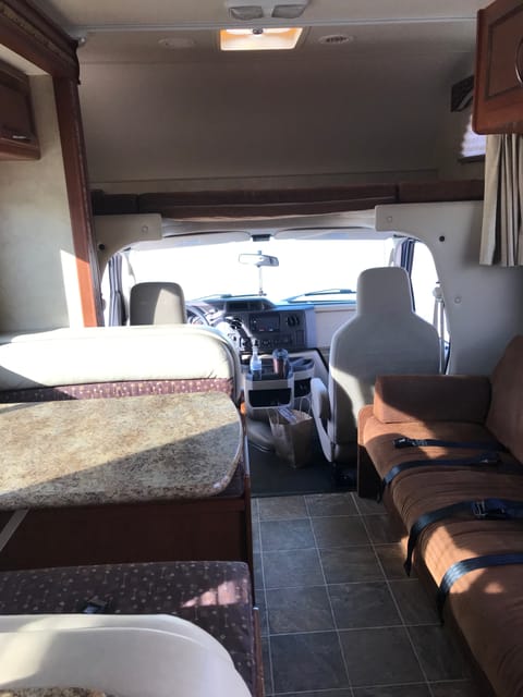 View of lounge area looking towards the front of the RV.  Pull-out sofa is on the right, and drop-down table is on the left.  Both of these make into comfortable (for an RV) beds.  Very easy to use as well.